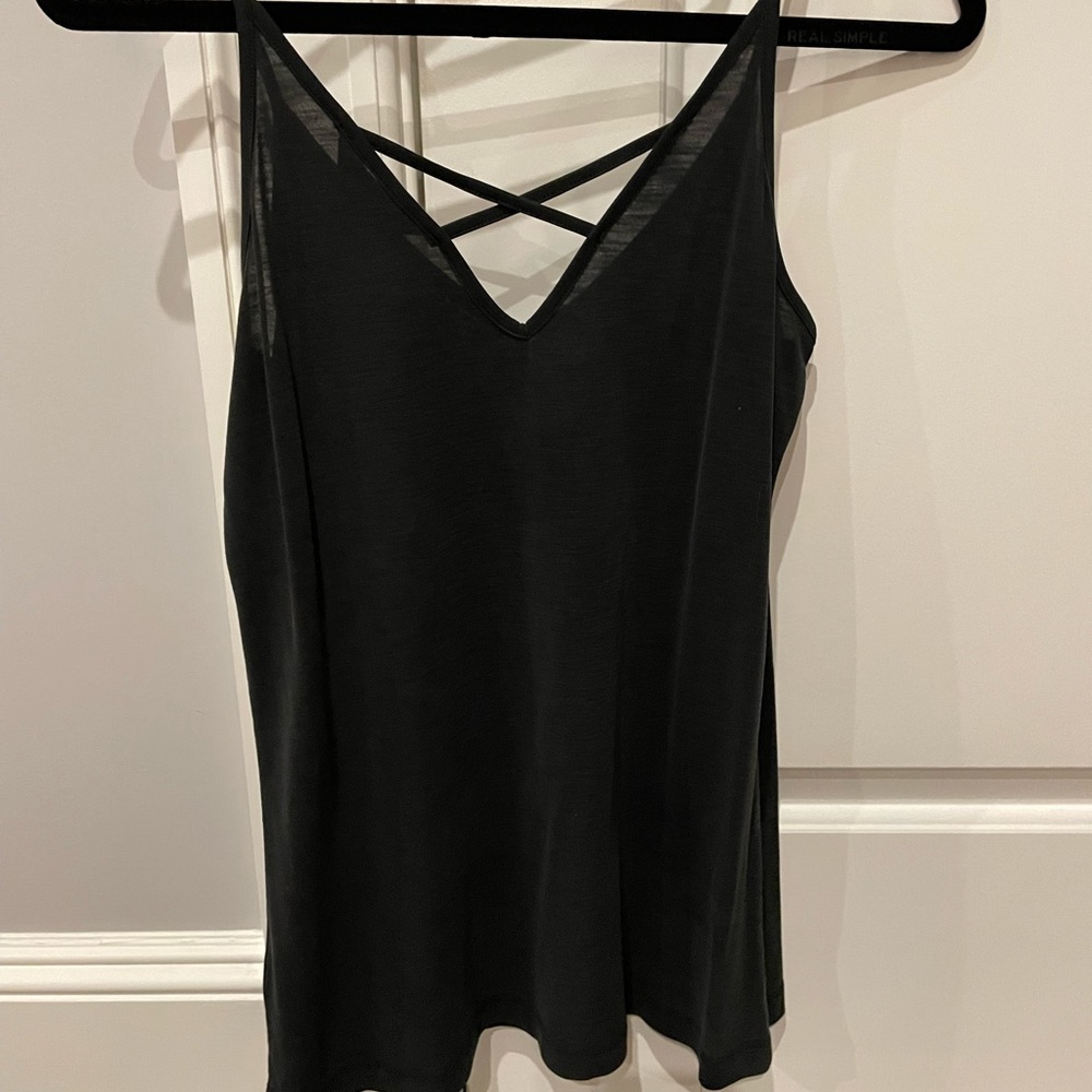 Silky tank top with criss cross detail on back.